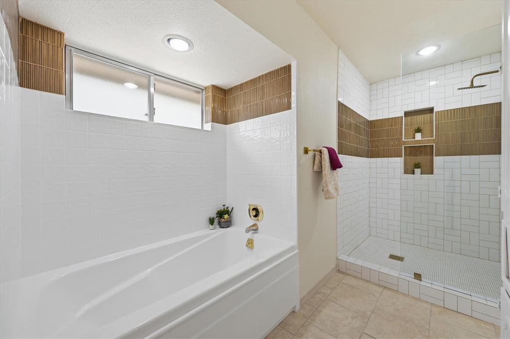 5808 Ridge Drive Arlington, TX 76016 - Photo 31 of 40 a bathroom with a bathtub and a shower