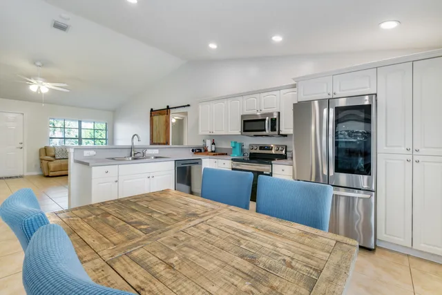 a kitchen with granite countertop stainless steel appliances and refrigerator