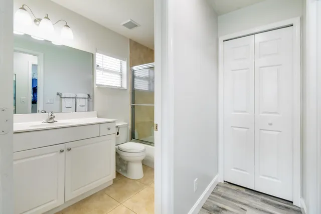 a bathroom with a toilet sink and a mirror