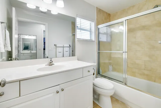 a bathroom with a sink toilet vanity and shower