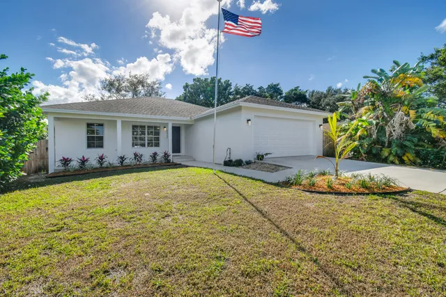 a view of a house with swimming pool and yard