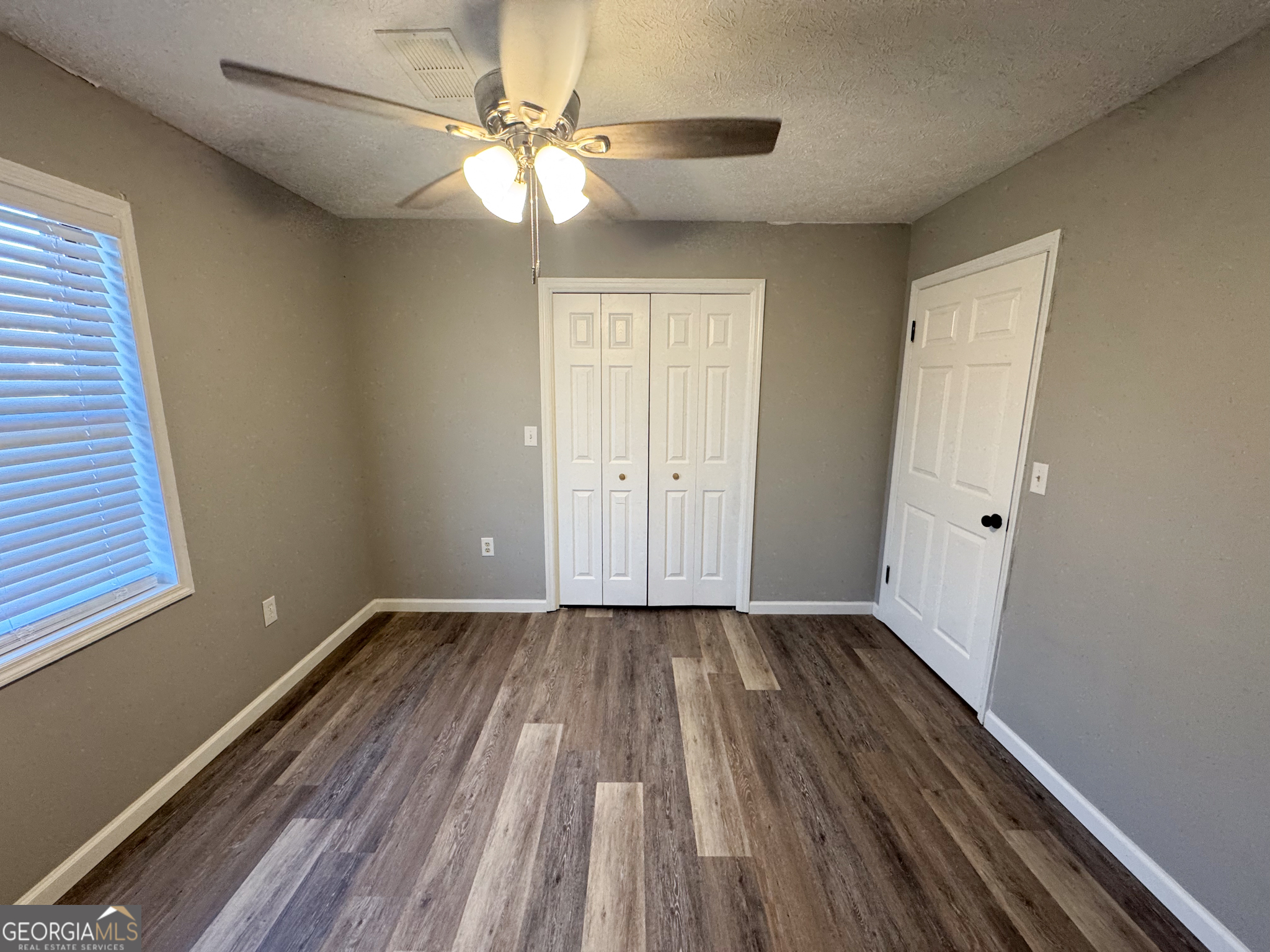 1705 Moses Drive Vidalia, GA 30474 - Photo 11 of 23 a view of an empty room with wooden floor and a window