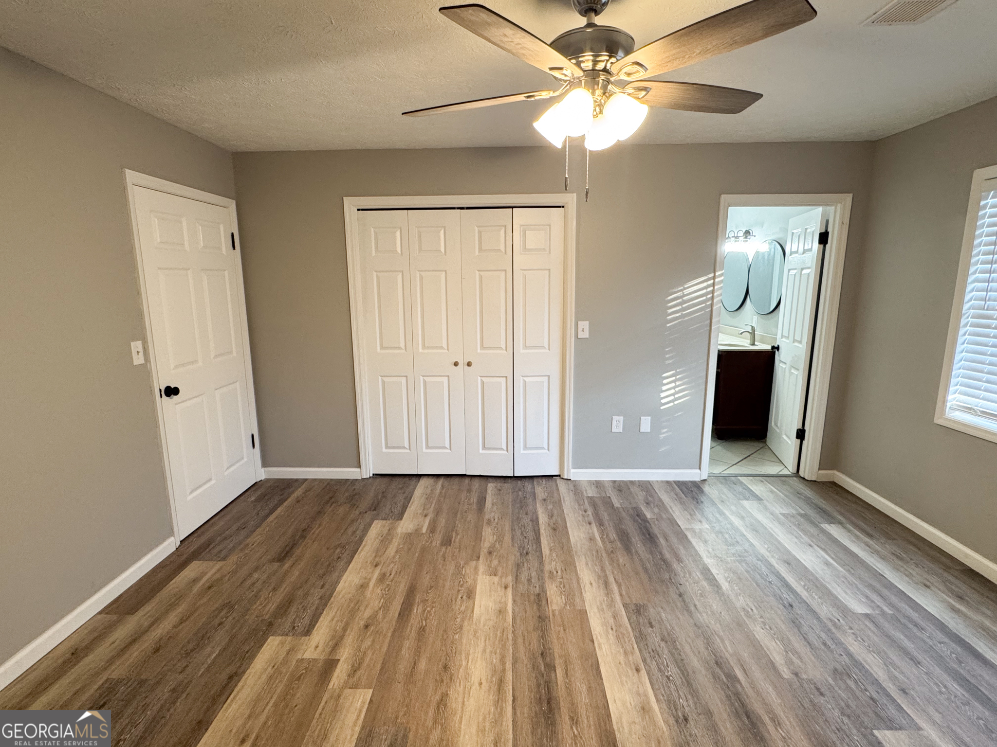 1705 Moses Drive Vidalia, GA 30474 - Photo 7 of 23 an empty room with closet and a ceiling fan