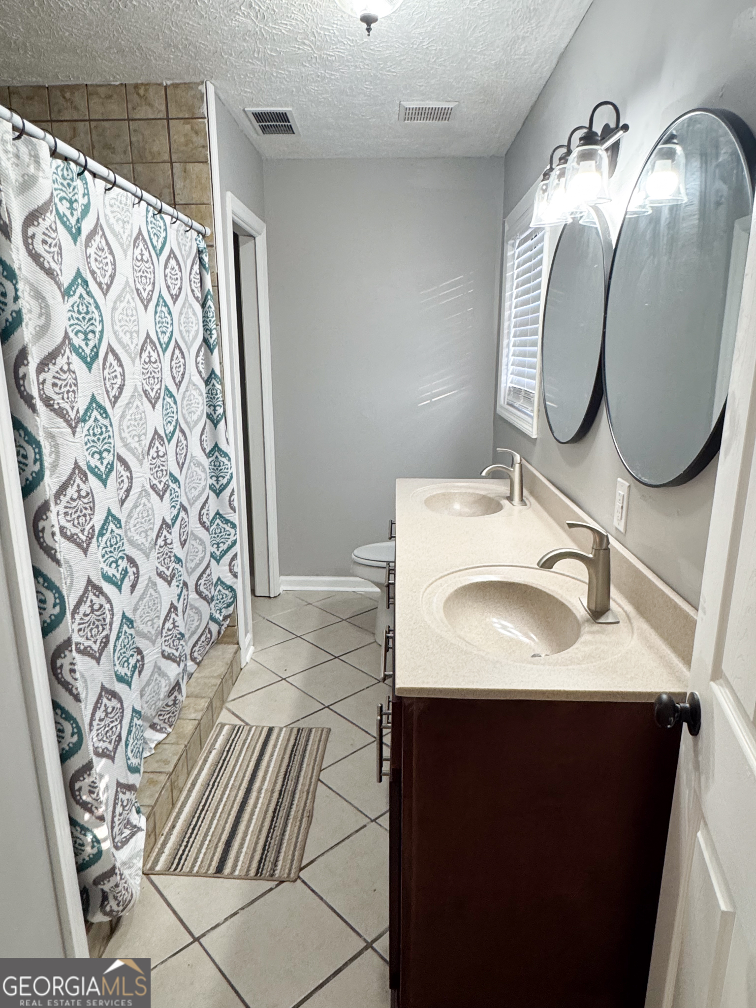 1705 Moses Drive Vidalia, GA 30474 - Photo 8 of 23 a bathroom with a sink mirror and shower