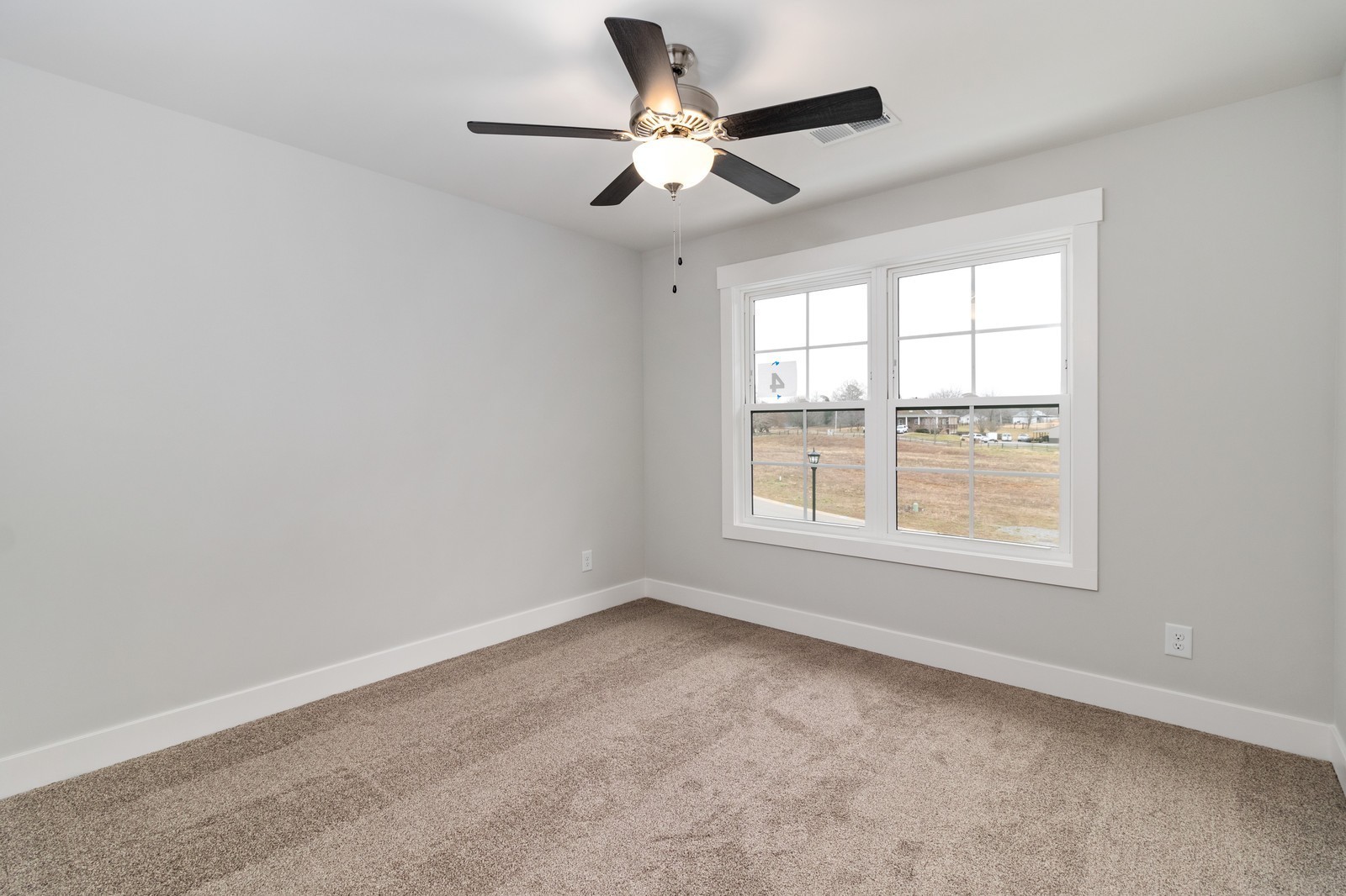24 Port Royal Estate Adams, TN 37010 - Photo 31 of 37 an empty room with a window and a ceiling fan