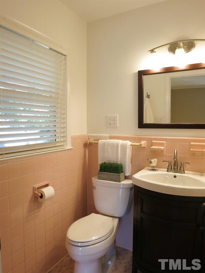 105 Dartmouth Road Raleigh, NC 27609 - Photo 17 of 25 The Master Bath has been updated w/newer vanity-sink, mirror, light fixture & faucet and tiled tub/shower.