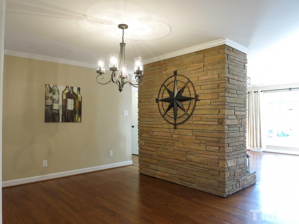 105 Dartmouth Road Raleigh, NC 27609 - Photo 5 of 25 Dining Rm features a stone wall & black iron light fixture, and it is open to the Kitchen.
