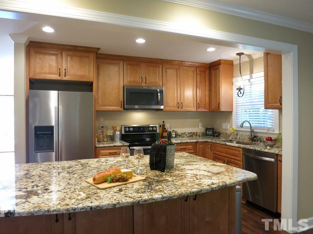 105 Dartmouth Road Raleigh, NC 27609 - Photo 7 of 25 The updated KIT features lots of tall maple cabs, gorgeous granite ctrs, Whirlpool Elite SS appls (smooth-top range w/dbl ovens), deep oversize stainless steel sink and recessed & pendant lighting. It is open over the big eat-at island to the Family Rm.