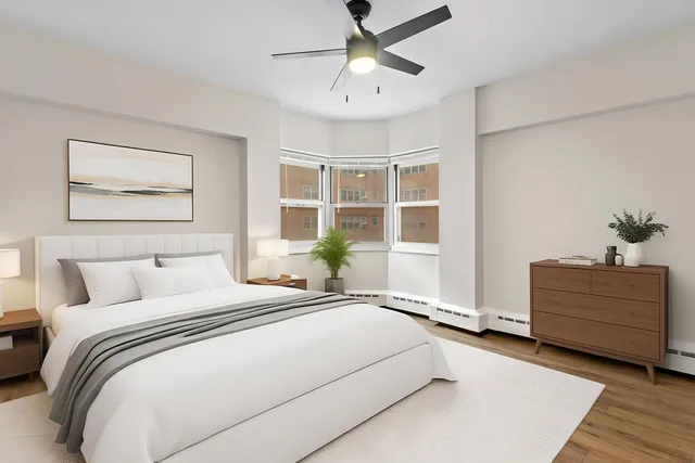 a bedroom with a bed and a window