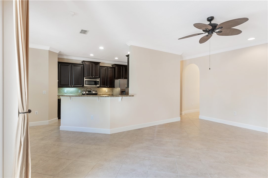 4231 Diamond Square Vero Beach, FL 32967 - Photo 12 of 28 a view of a kitchen with a sink stainless steel appliances and cabinets