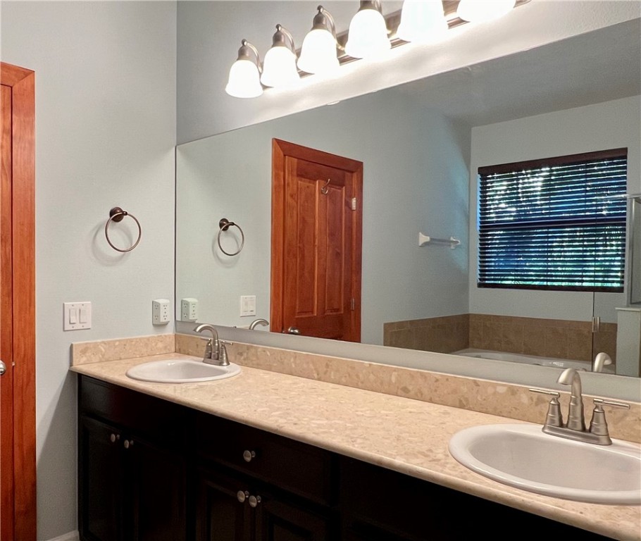 4231 Diamond Square Vero Beach, FL 32967 - Photo 19 of 28 a bathroom with a double vanity sink and a mirror