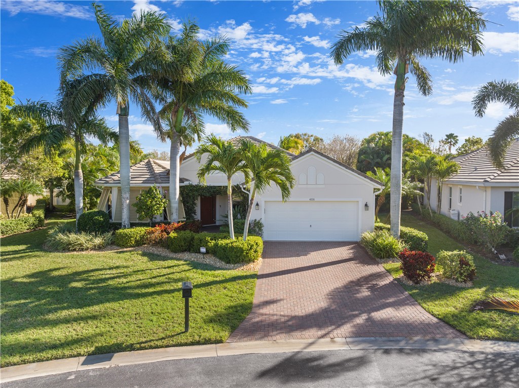 4231 Diamond Square Vero Beach, FL 32967 - Photo 2 of 28 a front view of a house with garden