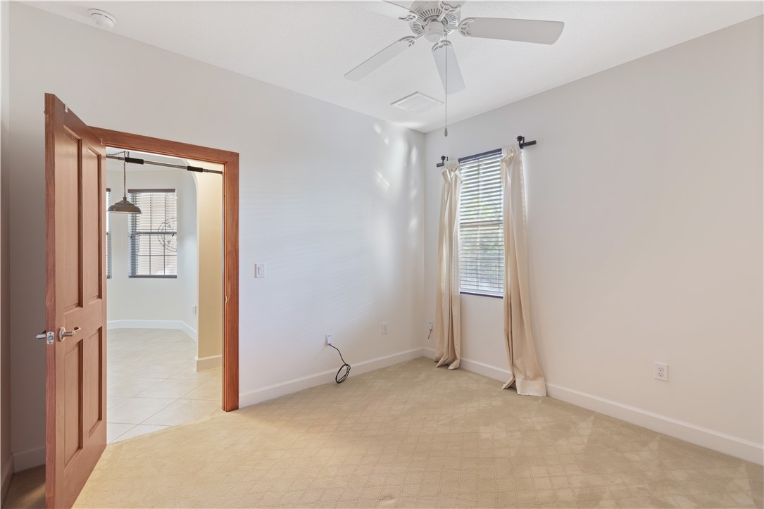 4231 Diamond Square Vero Beach, FL 32967 - Photo 22 of 28 an empty room with a ceiling fan and a window