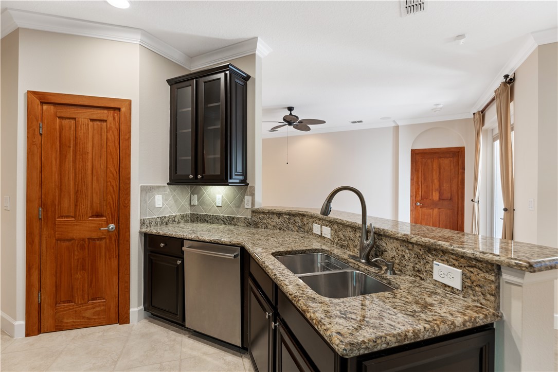 4231 Diamond Square Vero Beach, FL 32967 - Photo 10 of 28 a kitchen with granite countertop a sink and cabinets