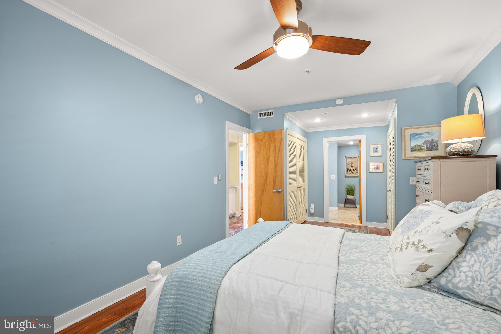 110 Anglers Road, Unit 206 Lewes, DE 19958 - Photo 18 of 40 a bedroom with a bed and a chandelier