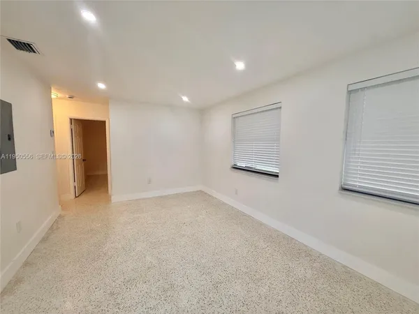 a view of an empty room with a window