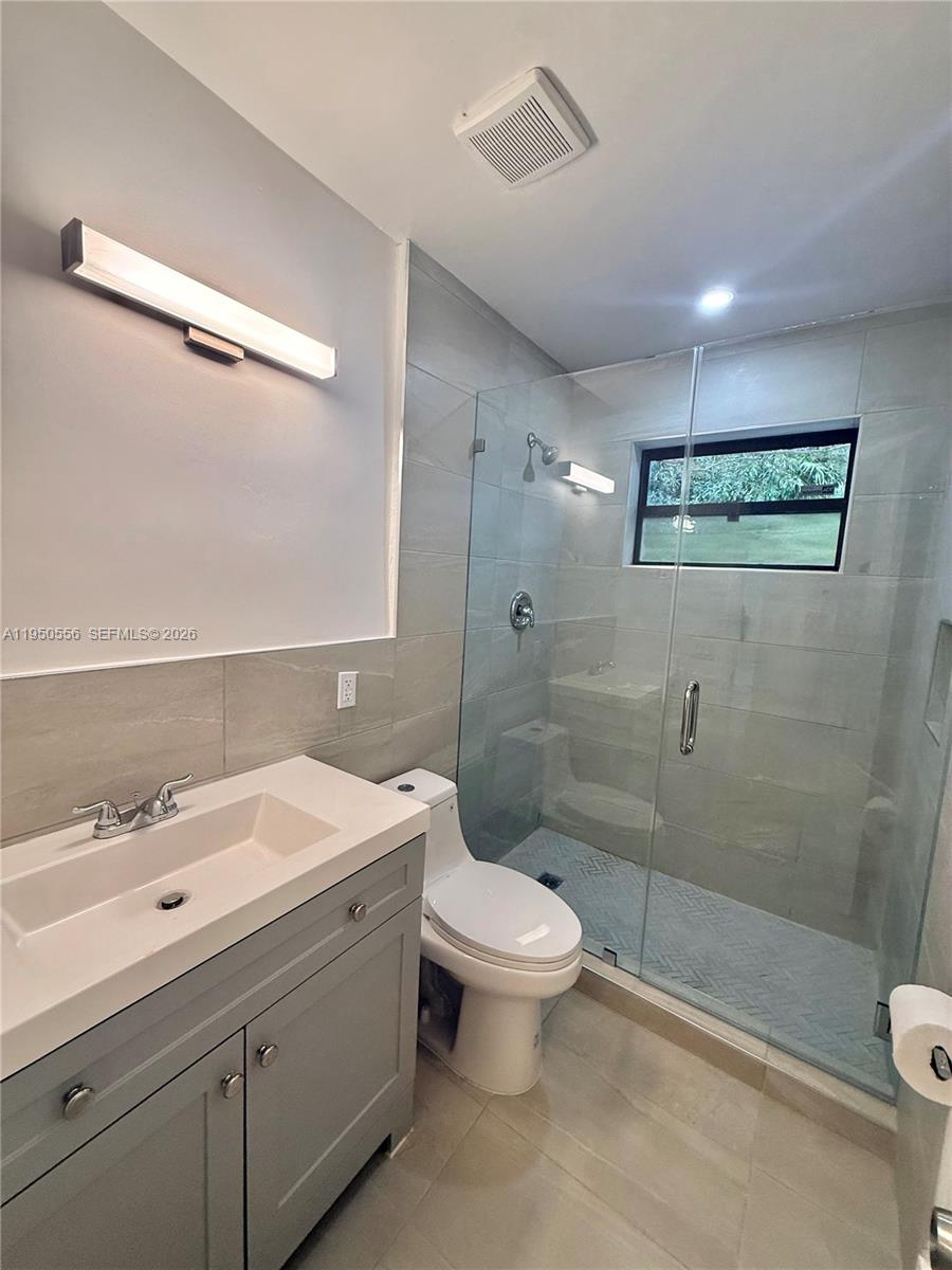 3400 Southwest 17th Street, Unit 1 Miami, FL 33145 - Photo 5 of 10 a bathroom with a sink a toilet and shower