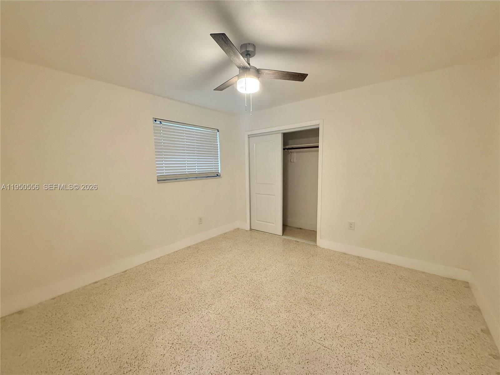 3400 Southwest 17th Street, Unit 1 Miami, FL 33145 - Photo 7 of 10 an empty room with a ceiling fan and a window