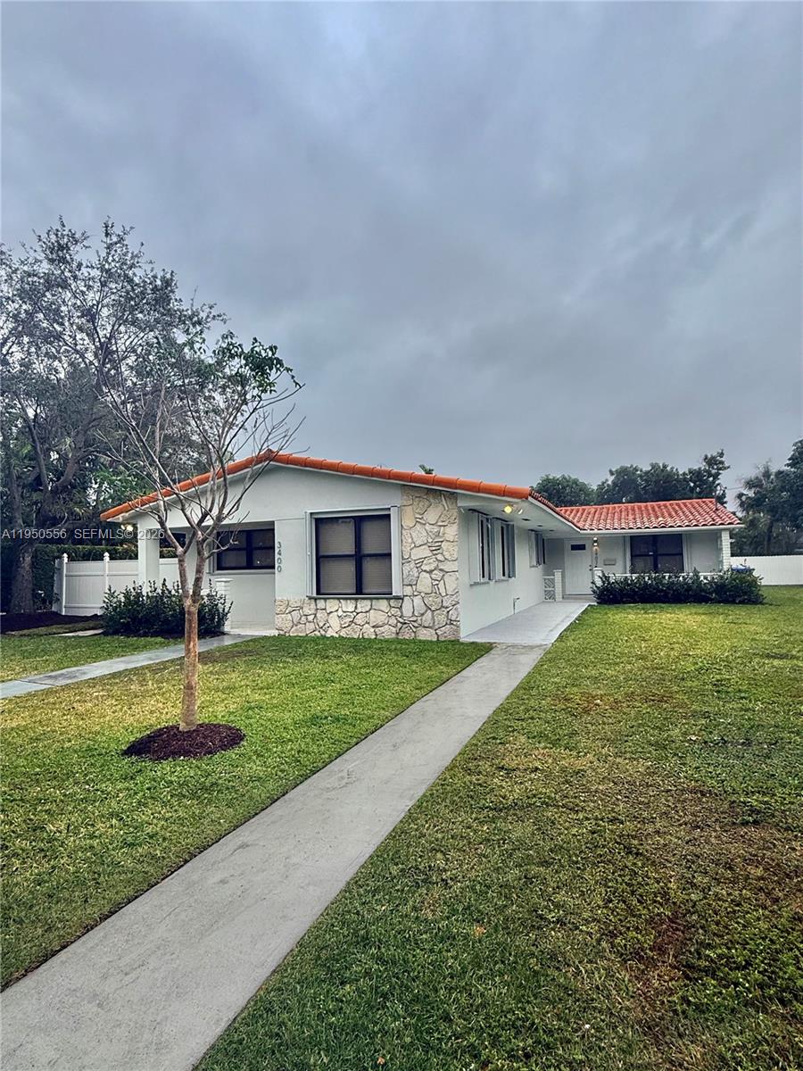 3400 Southwest 17th Street, Unit 1 Miami, FL 33145 - Photo 10 of 10 a house with a big yard and large trees