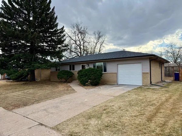 a view of a house with a yard and garage