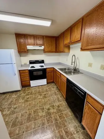 a kitchen with stainless steel appliances granite countertop a sink stove and cabinets