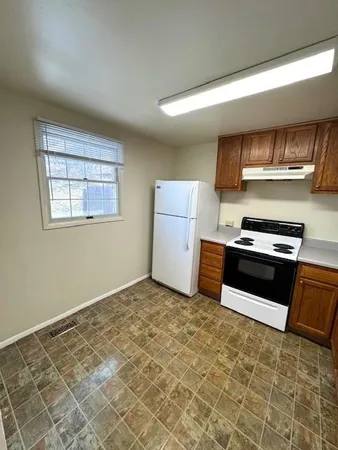a kitchen with a stove and a refrigerator
