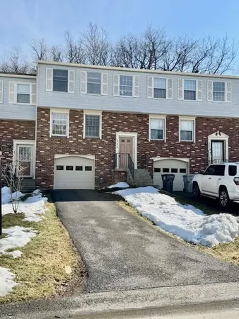 a view of a house with snow in the background