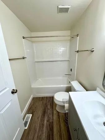 a bathroom with a sink a toilet a shower and a mirror