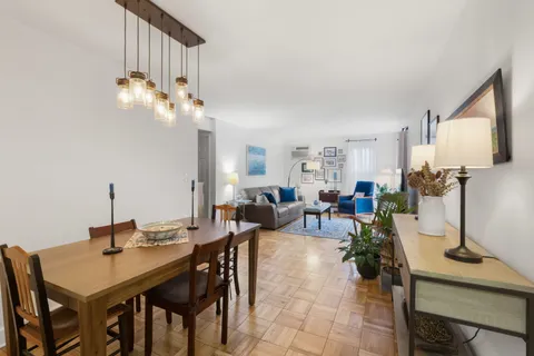 a view of a dining room with furniture and a chandelier