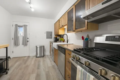 a kitchen with stainless steel appliances granite countertop a stove and a sink
