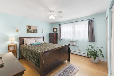 a bedroom with a large bed and a chandelier