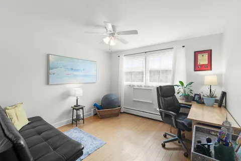 a livingroom with workspace and a couch