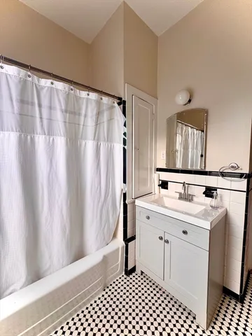 a bathroom with a sink a toilet and a shower