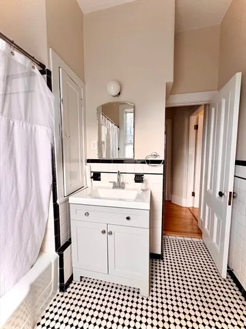 a kitchen with a stove a sink and a shower