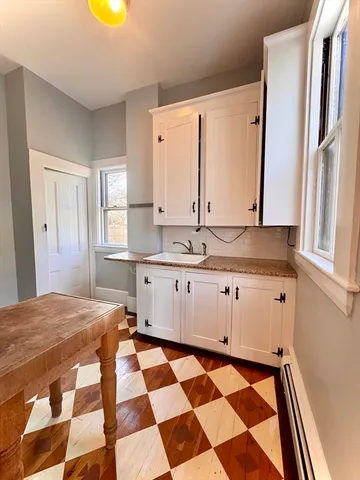 a kitchen with a sink dishwasher and cabinets