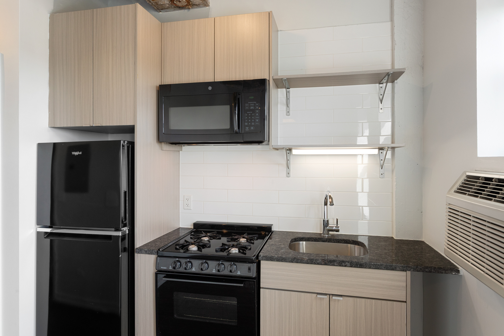 1325 West Wilson Avenue, Unit 605 Chicago, IL 60640 - Photo 6 of 20 a kitchen with appliances a sink and cabinets