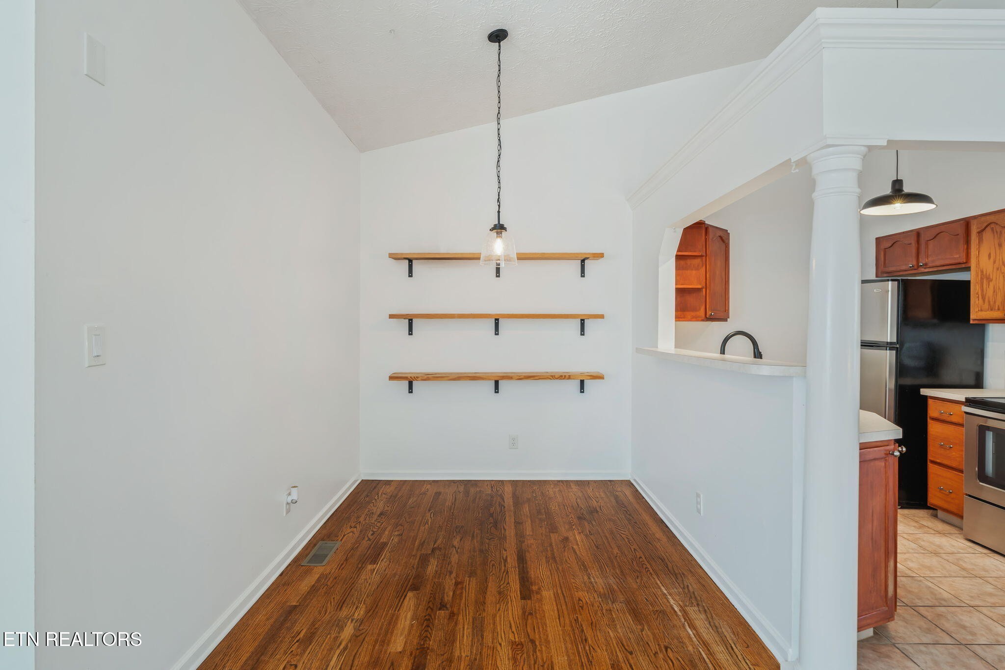 8533 Constance Way Knoxville, TN 37923 - Photo 12 of 30 a view of a hallway with wooden floor and a fireplace