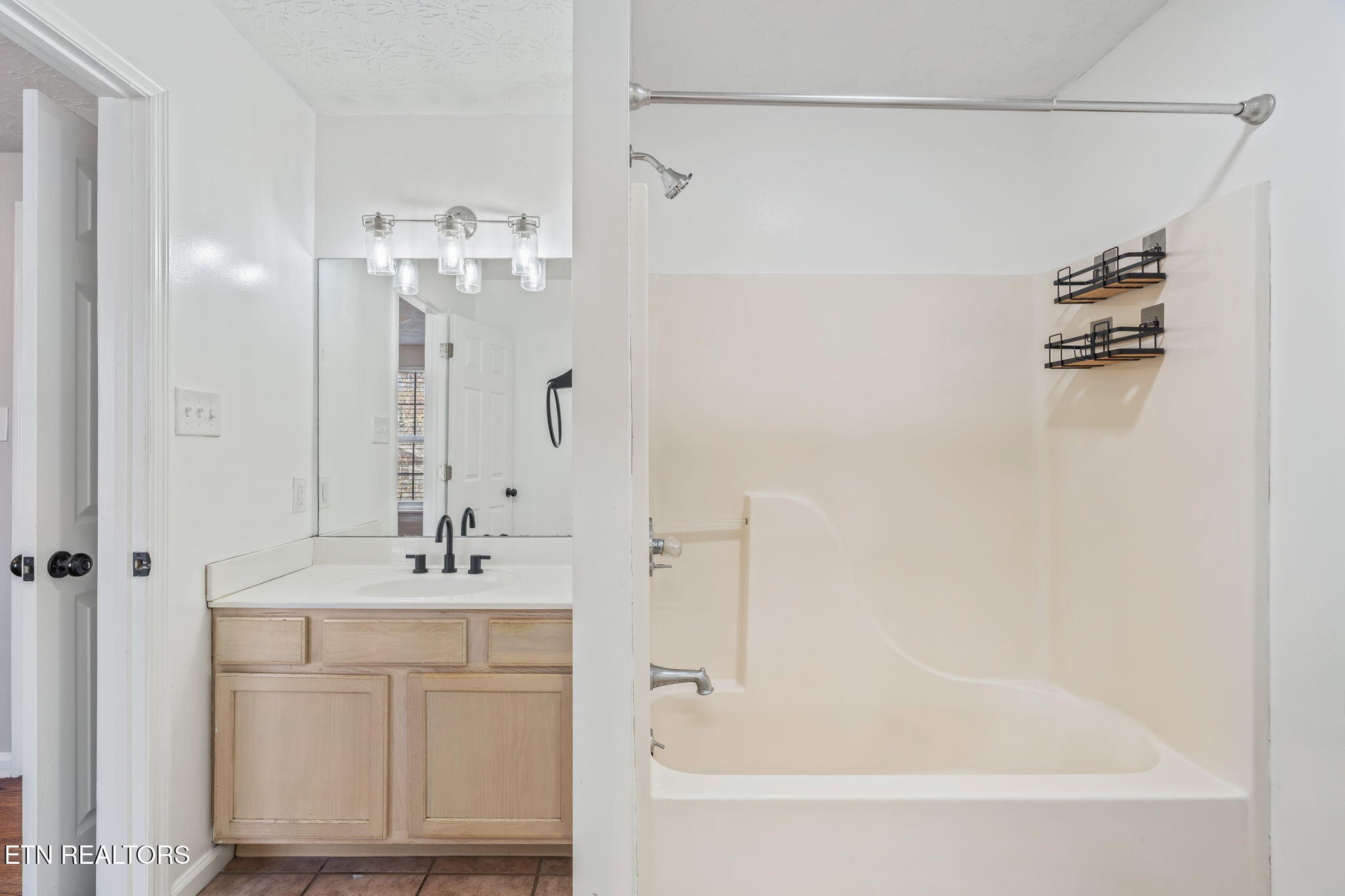 8533 Constance Way Knoxville, TN 37923 - Photo 16 of 30 a bathroom with a bathtub a sink and a mirror