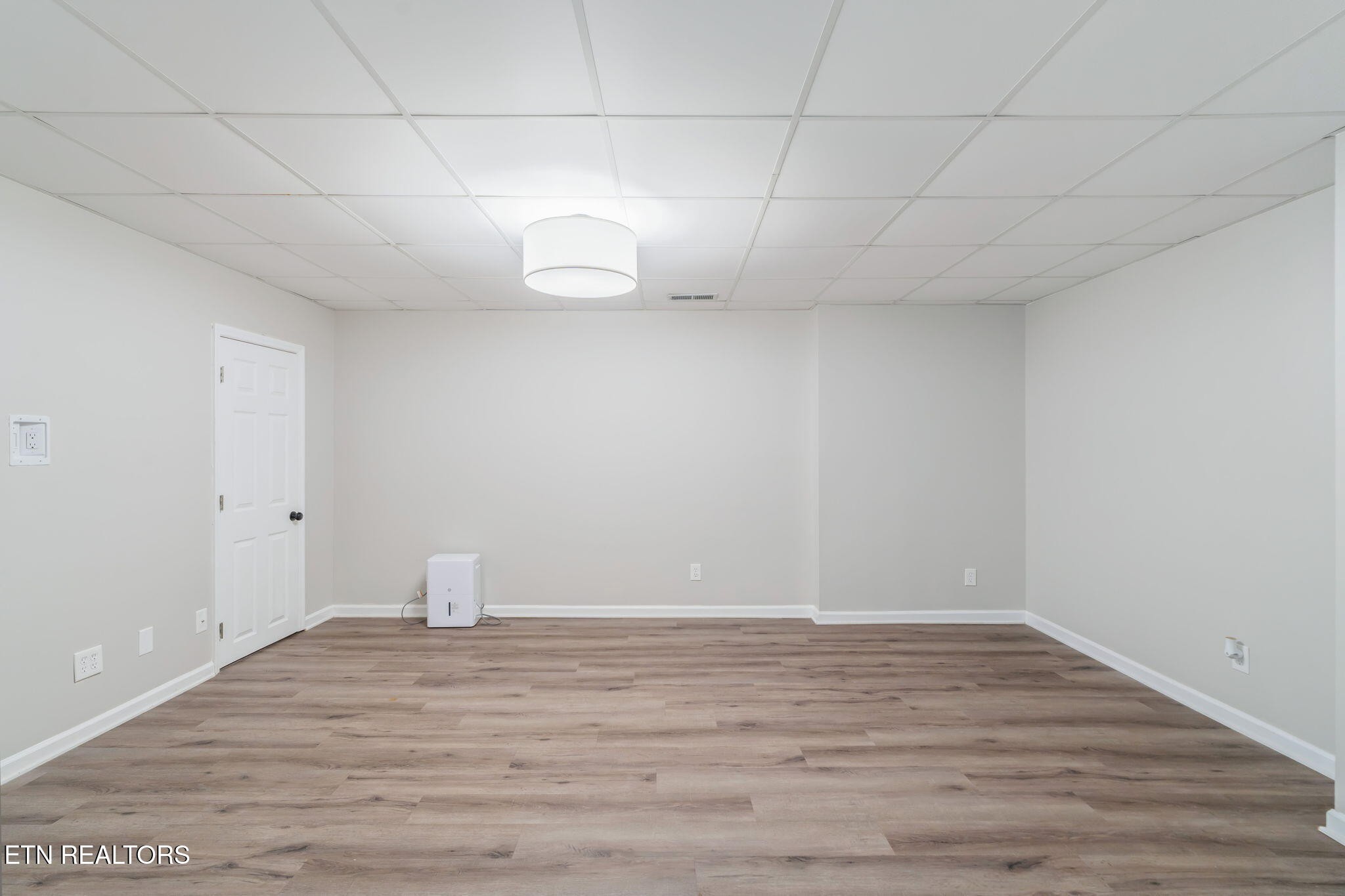 8533 Constance Way Knoxville, TN 37923 - Photo 18 of 30 a view of a room with wooden floor and white walls
