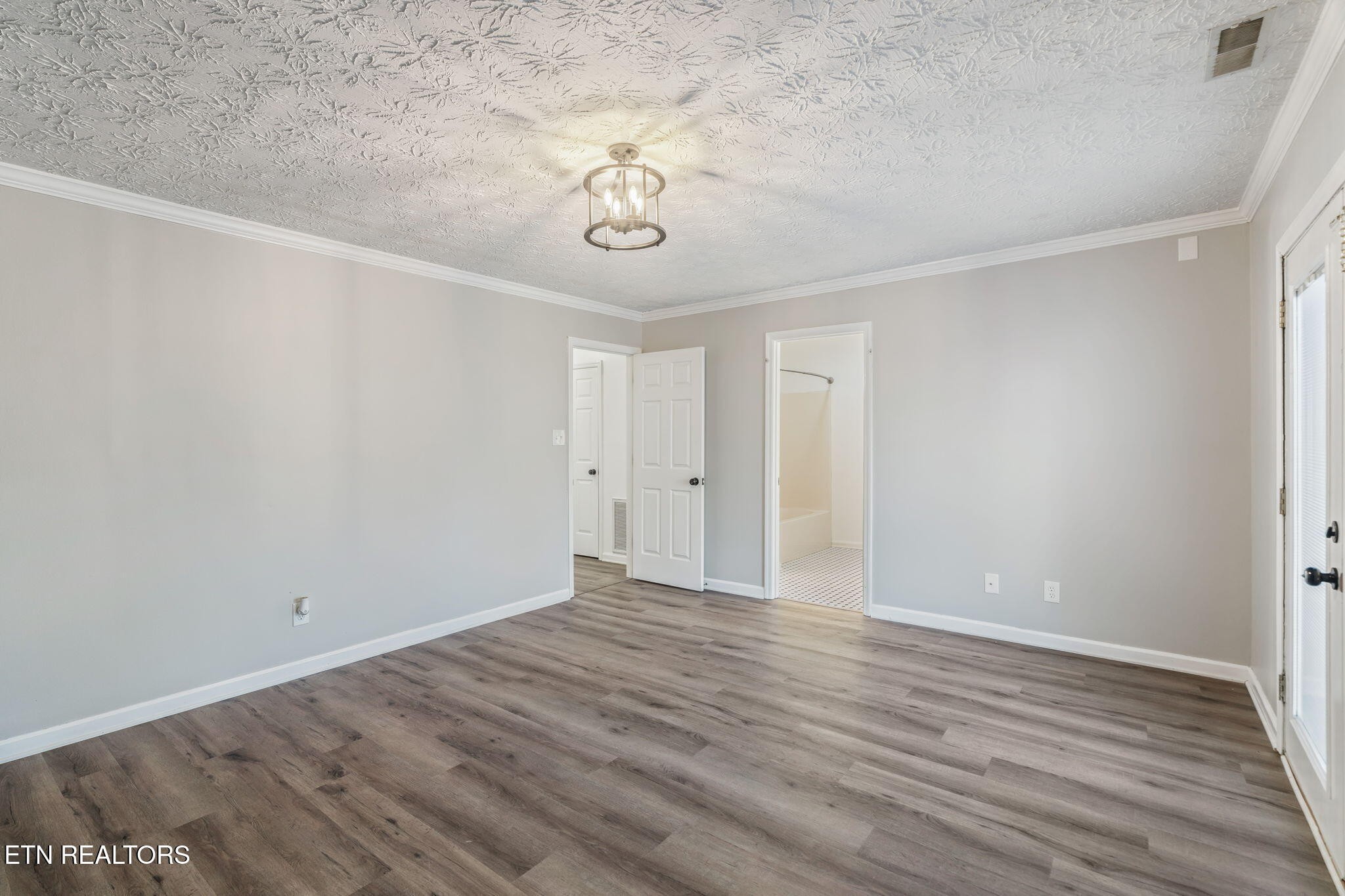 8533 Constance Way Knoxville, TN 37923 - Photo 23 of 30 a view of an empty room with wooden floor