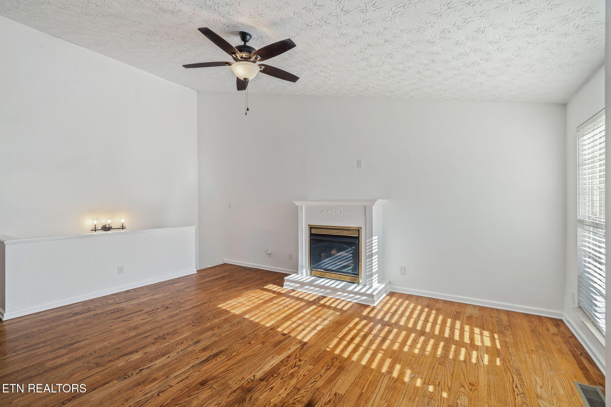 8533 Constance Way Knoxville, TN 37923 - Photo 4 of 30 a view of empty room with wooden floor and fan