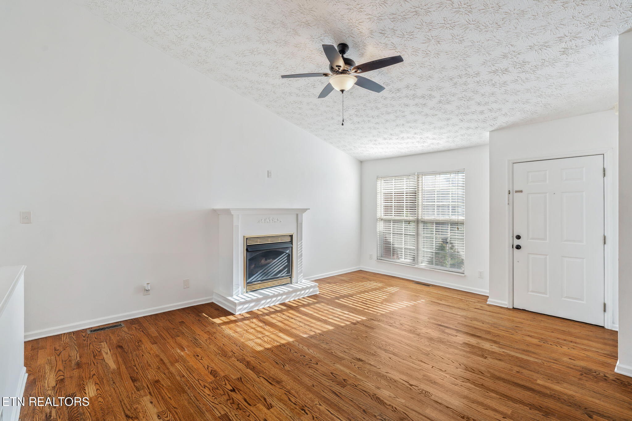 8533 Constance Way Knoxville, TN 37923 - Photo 8 of 30 a view of empty room with wooden floor and fan