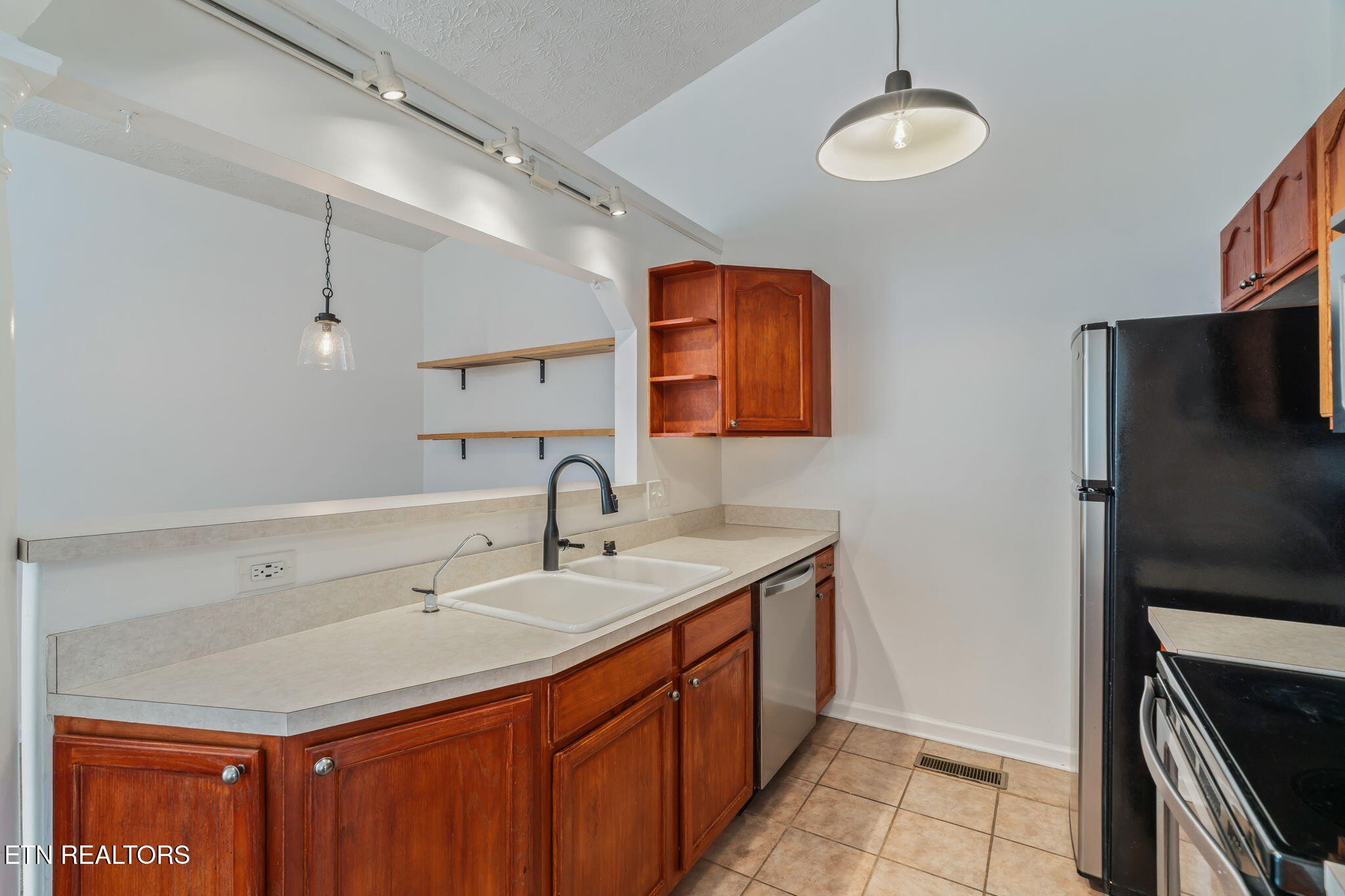 8533 Constance Way Knoxville, TN 37923 - Photo 10 of 30 a kitchen with a sink and a refrigerator