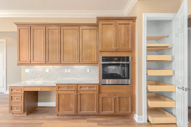 a kitchen with granite countertop white cabinets and stainless steel appliances