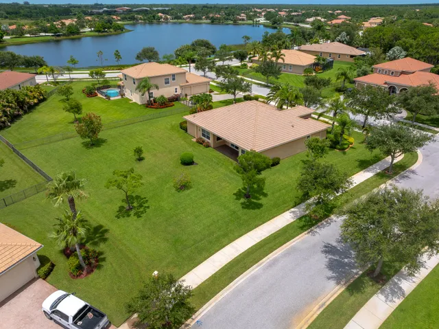an aerial view of residential houses with outdoor space and river