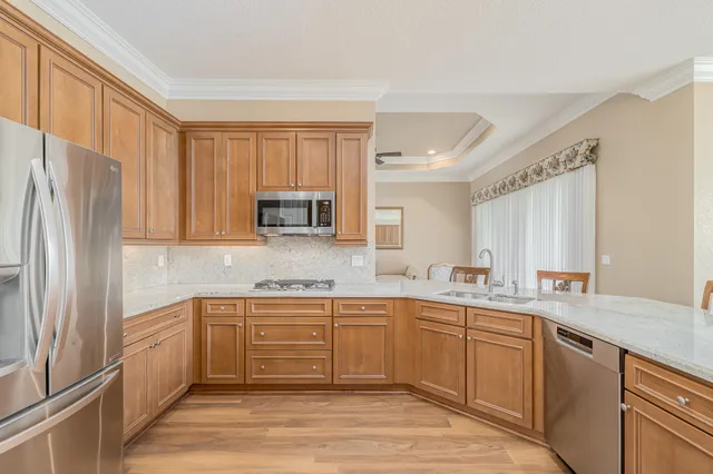 a kitchen with a sink stainless steel appliances and cabinets