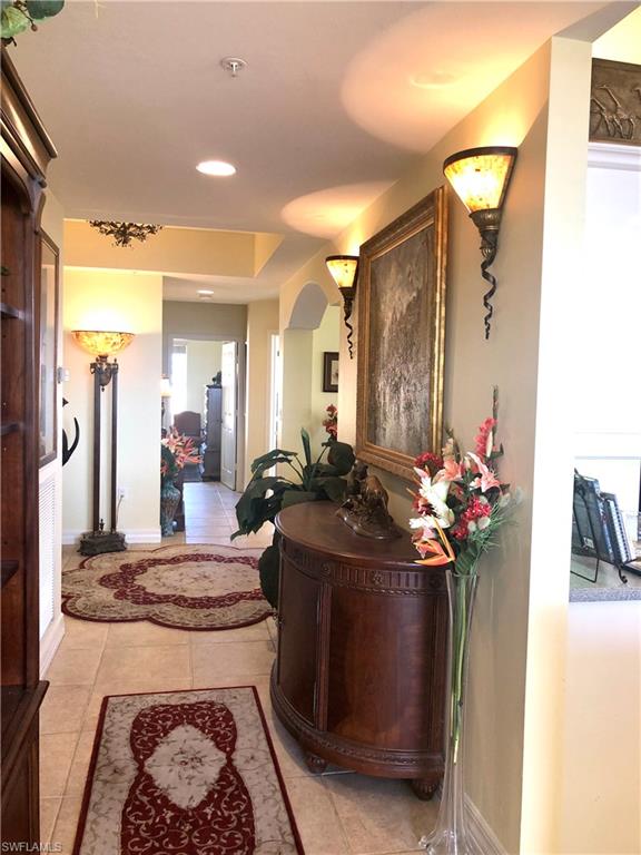 451 Bayfront Place, Unit 5311 Naples, FL 34102 - Photo 12 of 38 a view of a hallway and a dining area with chandelier