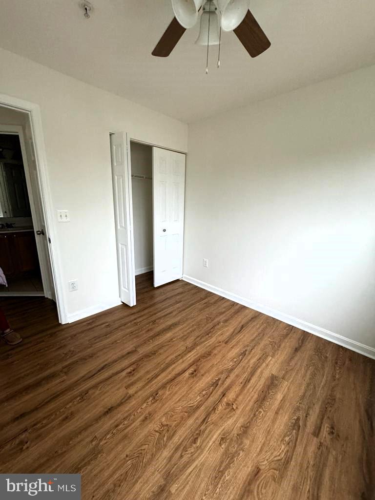 7520 Maury Road Baltimore, MD 21244 - Photo 12 of 29 an empty room with wooden floor and ceiling fan