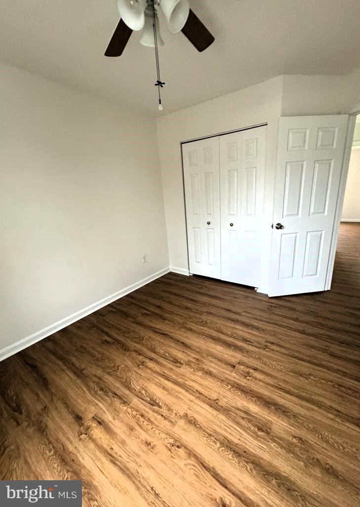 7520 Maury Road Baltimore, MD 21244 - Photo 14 of 29 an empty room with wooden floor fan and windows