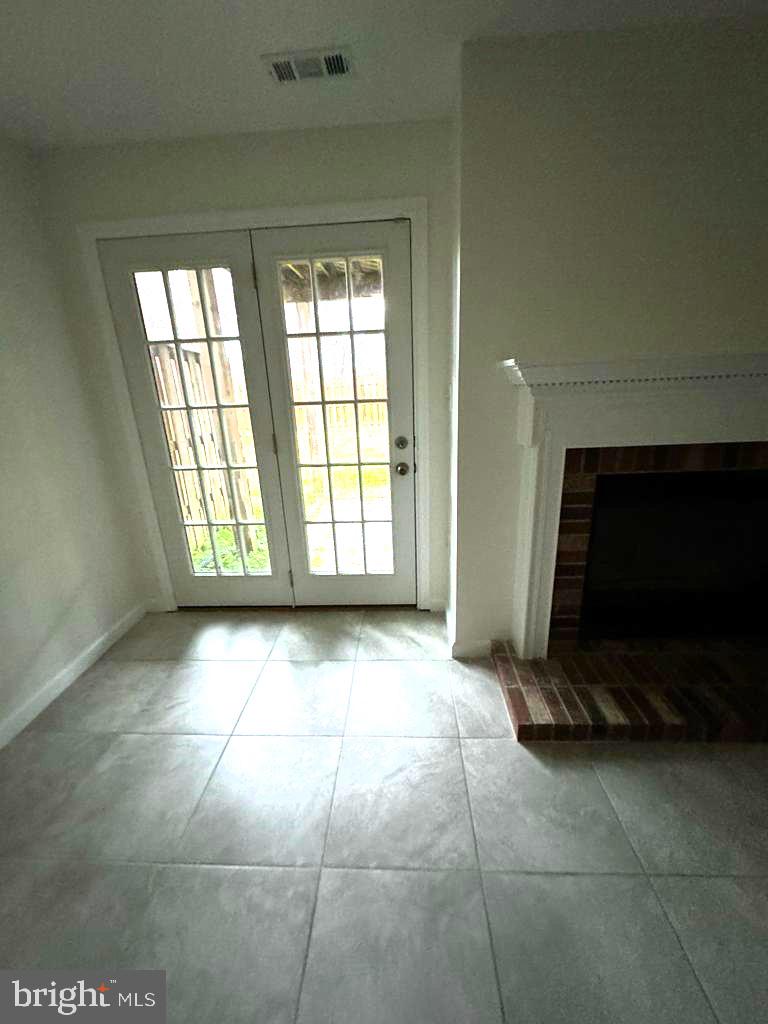 7520 Maury Road Baltimore, MD 21244 - Photo 16 of 29 a view of an empty room with a fireplace and a window